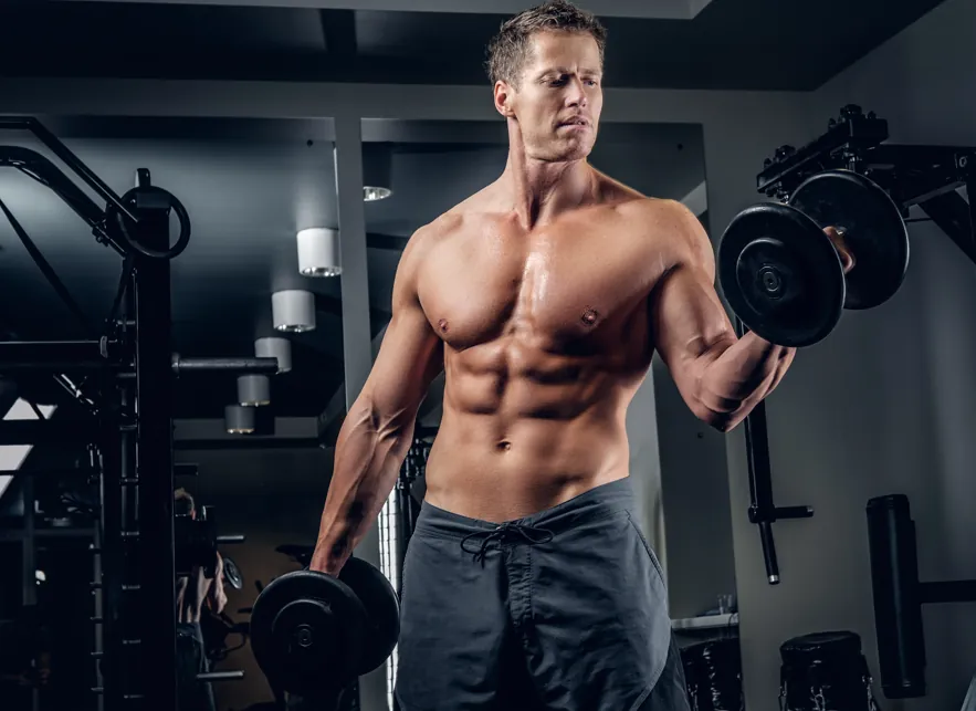 Member training with dumbbells at Strong Body & Mind gym in St Helier, Jersey