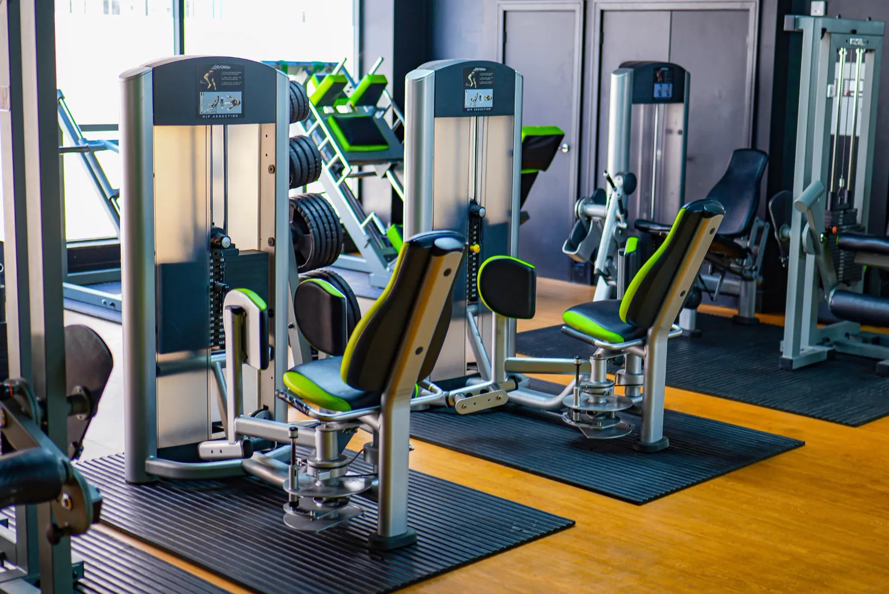 Leg machines lined up on the strength floor