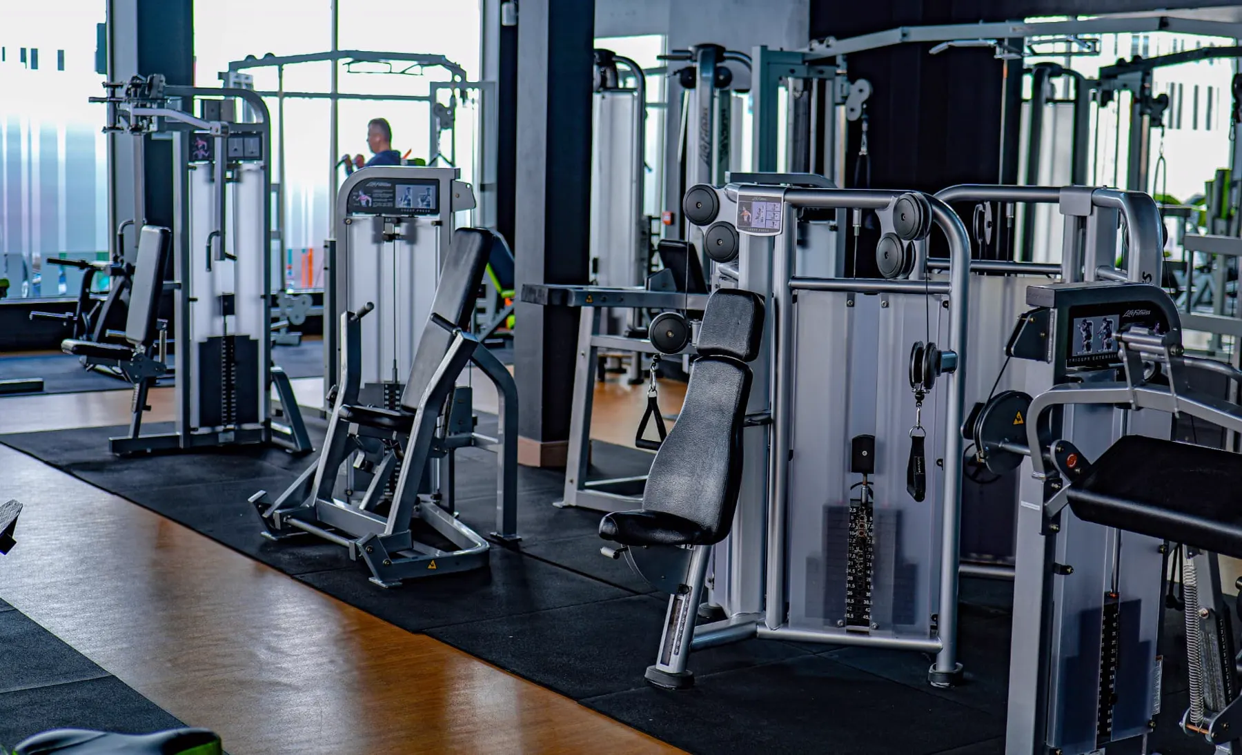 Chest press and cable machines under natural daylight