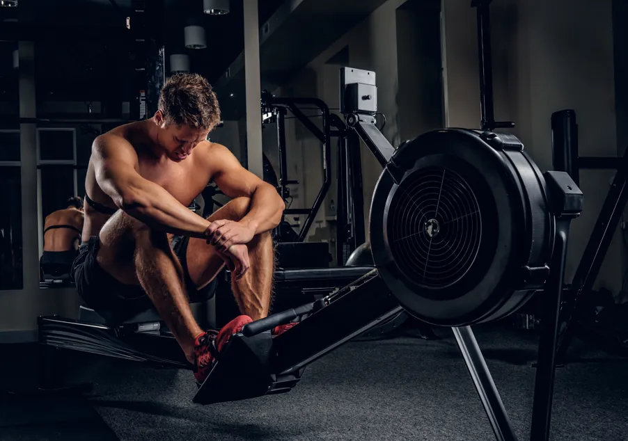 Member catching their breath on the rowing machine after a hard session